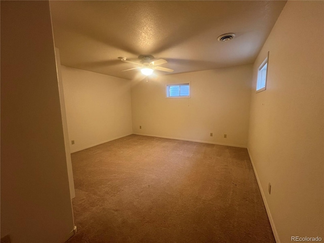 carpeted spare room with ceiling fan