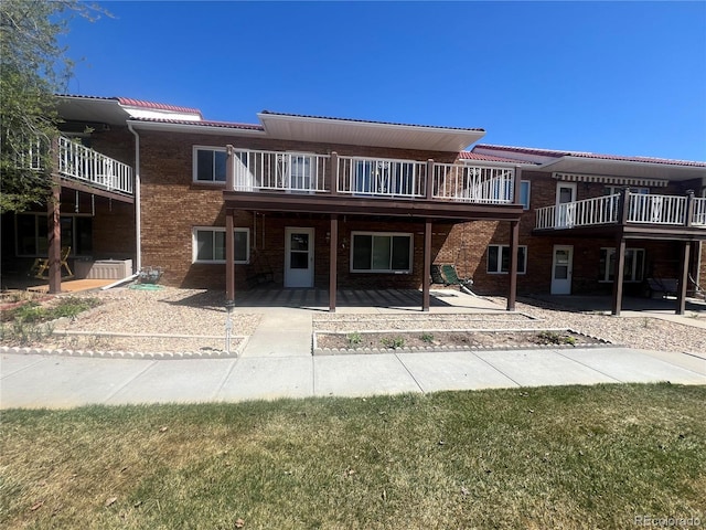 127 Fairway Ln, Fort Morgan, CO 80701 - view of front facade featuring a patio area, a tile roof, and brick siding