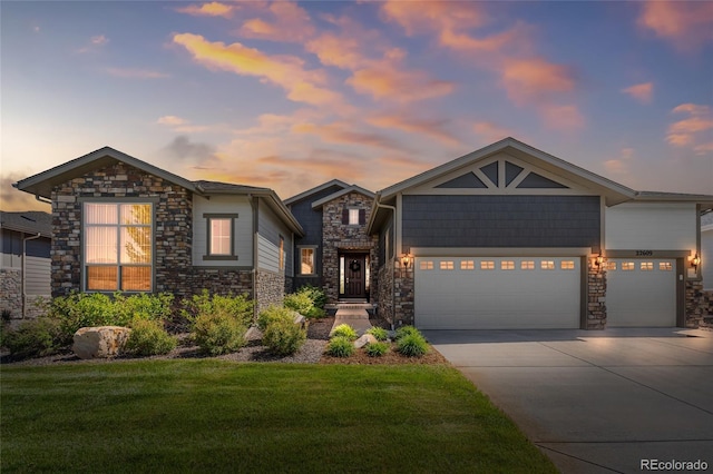22609 E Eads Cir, Aurora, CO 80016 - view of front of property with stone siding, a lawn, a garage, and concrete driveway