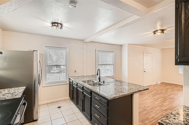 kitchen featuring a textured ceiling, plenty of natural light, and sink