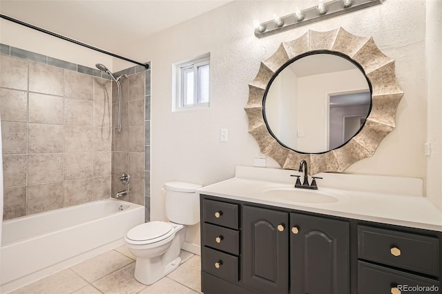 full bathroom with tile patterned floors, vanity, toilet, and tiled shower / bath