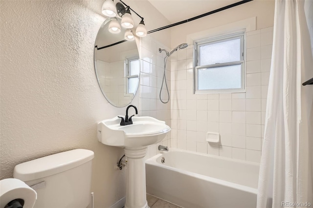 bathroom featuring toilet and shower / bath combo with shower curtain