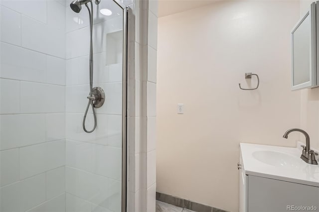 bathroom featuring vanity and an enclosed shower