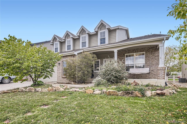 view of front of property featuring central AC unit and a front lawn