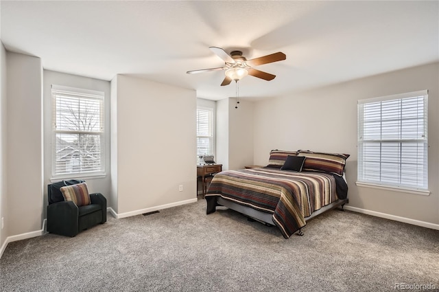 bedroom featuring multiple windows, carpet, and ceiling fan