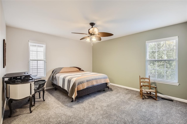 bedroom featuring ceiling fan and carpet