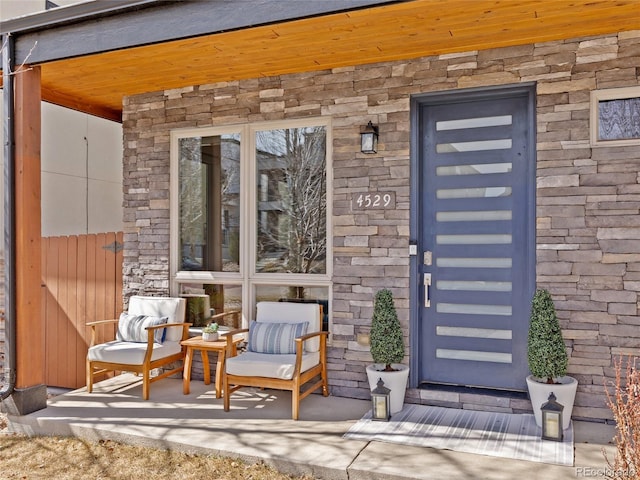 doorway to property featuring stone siding