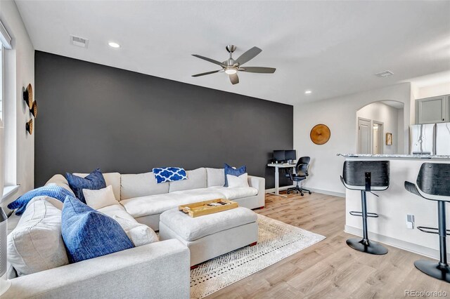 837 E 98th Ave Unit 403, Thornton, CO 80229 - living area featuring a ceiling fan, arched walkways, light wood-type flooring, recessed lighting, and baseboards