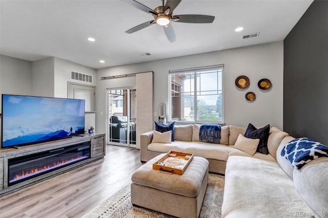 837 E 98th Ave Unit 403, Thornton, CO 80229 - living room featuring a glass covered fireplace, wood finished floors, ceiling fan, and recessed lighting