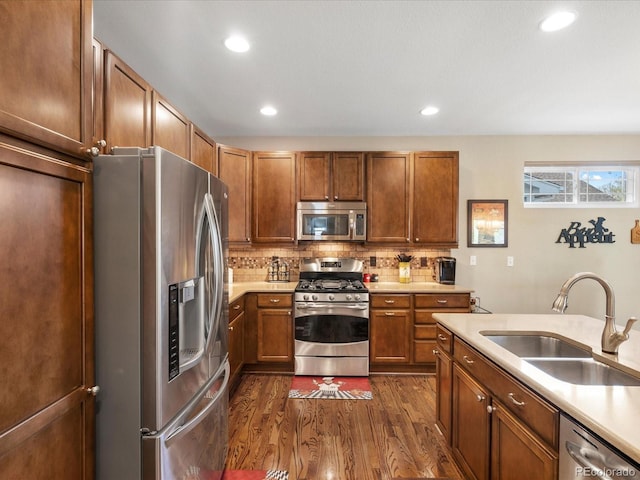 569 Jackson St, Lafayette, CO 80026 - kitchen with stainless steel appliances, dark wood-style flooring, light countertops, backsplash, and recessed lighting