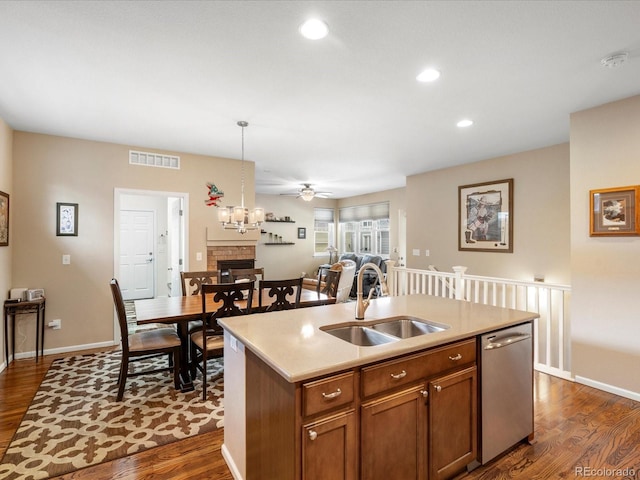 569 Jackson St, Lafayette, CO 80026 - kitchen featuring stainless steel dishwasher, dark wood-type flooring, light countertops, pendant lighting, and recessed lighting