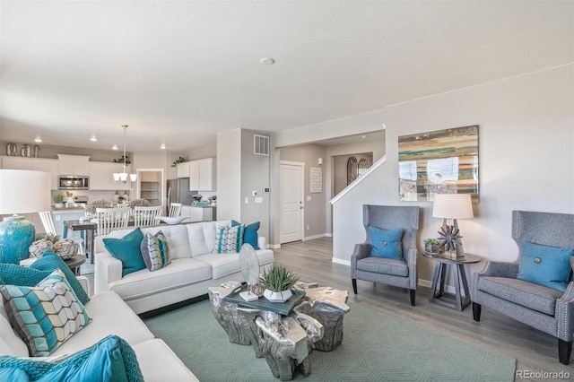 living room featuring hardwood / wood-style floors and a notable chandelier