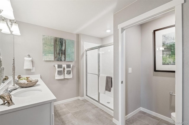 bathroom with vanity, toilet, and walk in shower