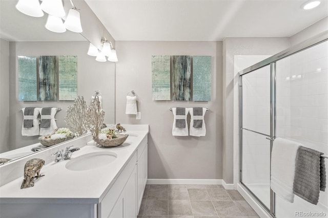 bathroom with a shower with door, tile patterned flooring, and vanity