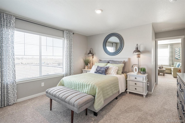 carpeted bedroom featuring multiple windows