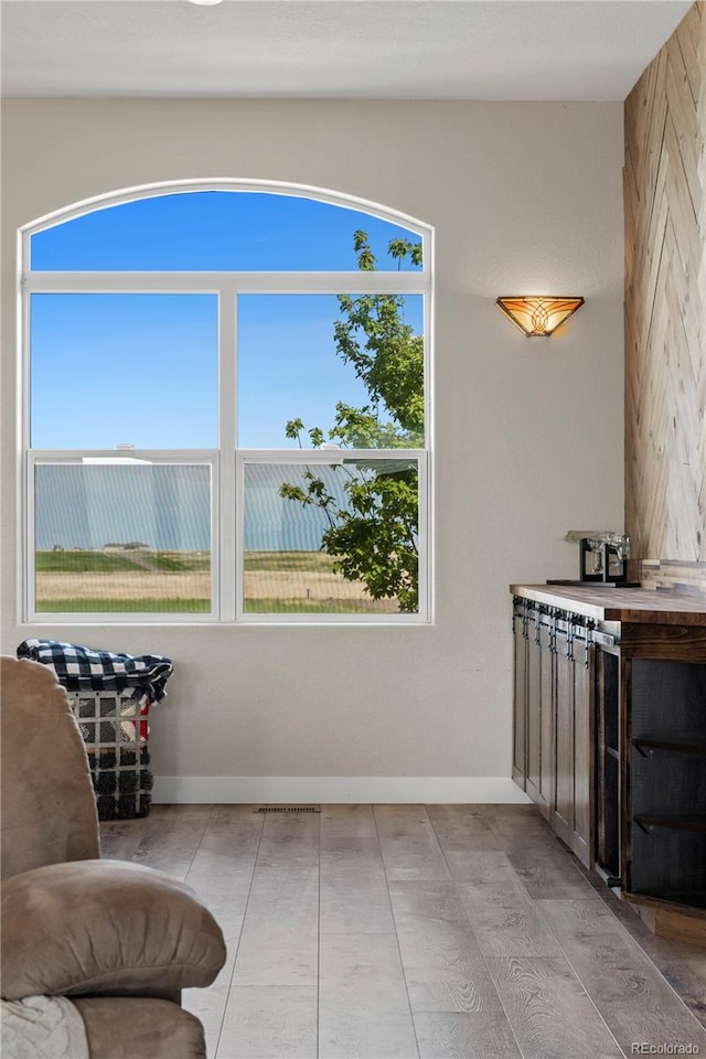 sitting room featuring a wealth of natural light and light hardwood / wood-style floors