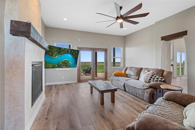 living room featuring light wood-type flooring and ceiling fan