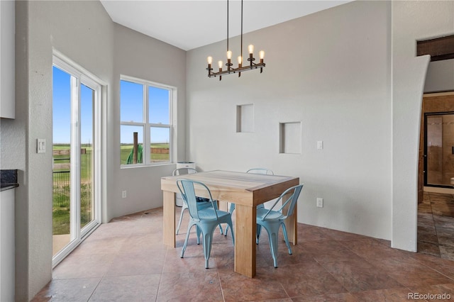 dining space with a healthy amount of sunlight and a chandelier