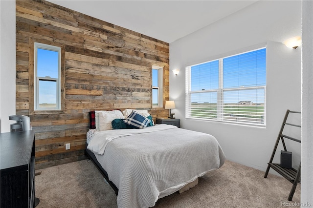 carpeted bedroom with wooden walls