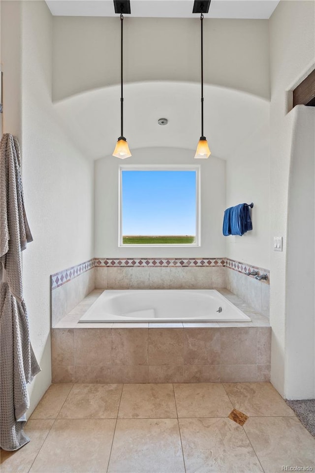 bathroom featuring tile patterned floors and tiled bath