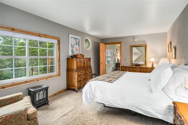 carpeted bedroom with a wood stove