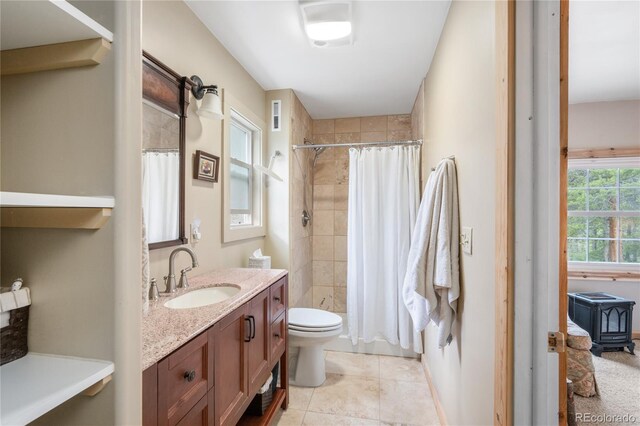 full bathroom featuring tile flooring, a wood stove, shower / bathtub combination with curtain, toilet, and vanity