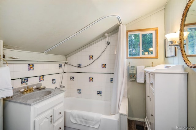 full bath featuring lofted ceiling, visible vents, shower / tub combo with curtain, and vanity