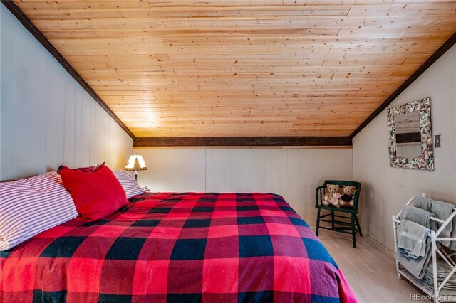 bedroom featuring wooden ceiling, wood-type flooring, and vaulted ceiling