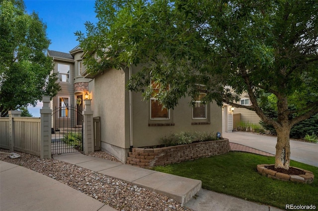 10837 Fox Sedge Way, Highlands Ranch, CO 80126 - view of front of property with a gate, concrete driveway, stucco siding, and a garage