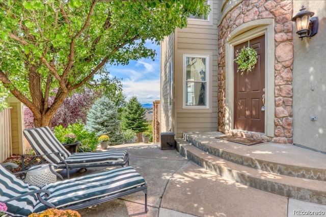 10837 Fox Sedge Way, Highlands Ranch, CO 80126 - doorway to property featuring stone siding and a patio area