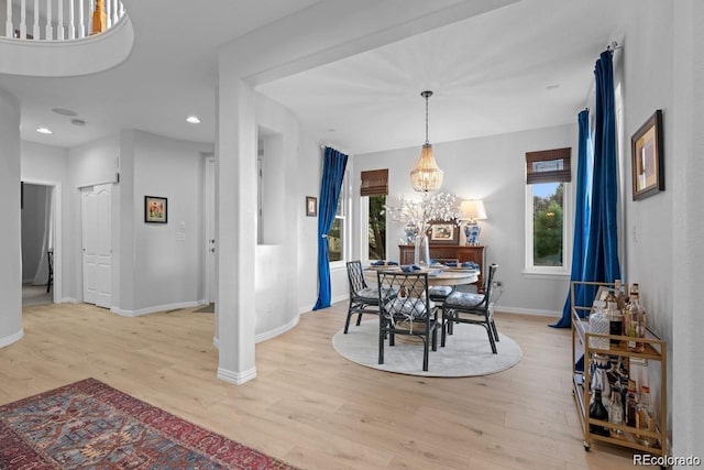 10837 Fox Sedge Way, Highlands Ranch, CO 80126 - dining space with light wood finished floors, healthy amount of natural light, recessed lighting, and a chandelier