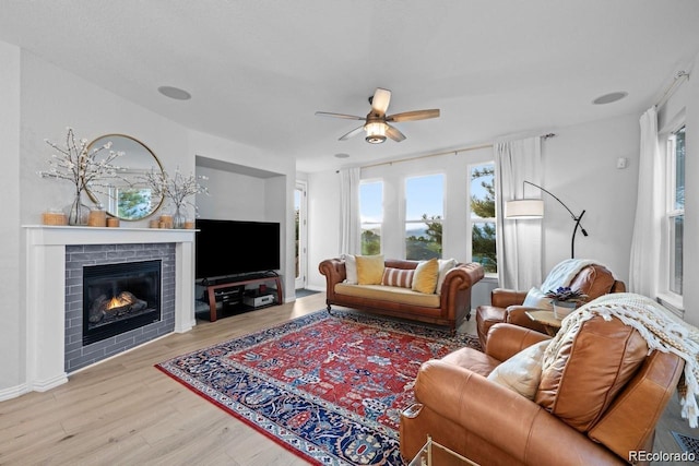 10837 Fox Sedge Way, Highlands Ranch, CO 80126 - living room featuring ceiling fan, wood finished floors, plenty of natural light, and a fireplace