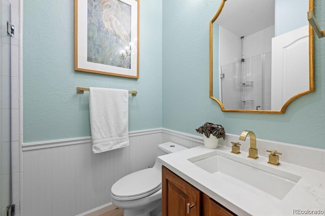 10837 Fox Sedge Way, Highlands Ranch, CO 80126 - bathroom with vanity, a wainscoted wall, and an enclosed shower