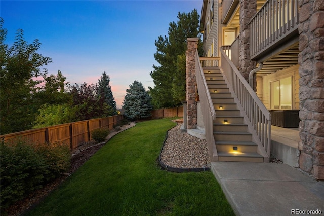 10837 Fox Sedge Way, Highlands Ranch, CO 80126 - yard at dusk featuring stairway and a fenced backyard