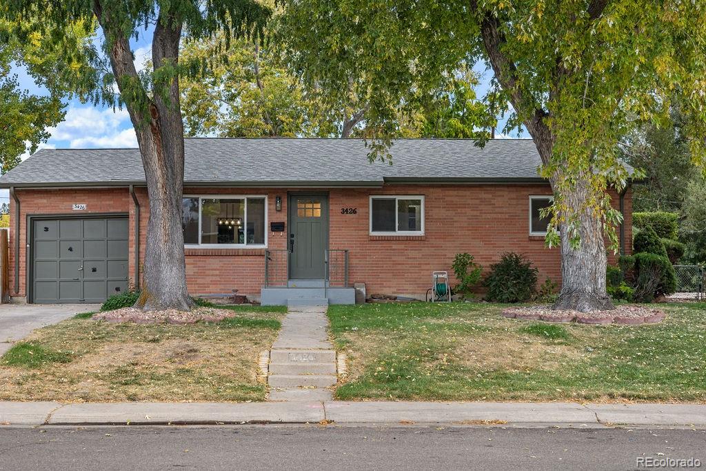 ranch-style home with a front yard and a garage