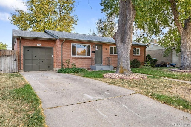 single story home featuring a garage and a front lawn