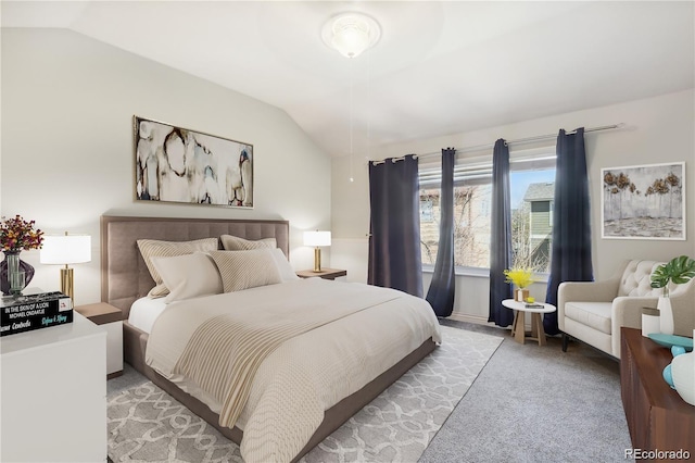 bedroom featuring lofted ceiling and light carpet