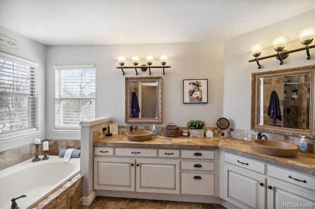 bathroom featuring vanity and a relaxing tiled tub