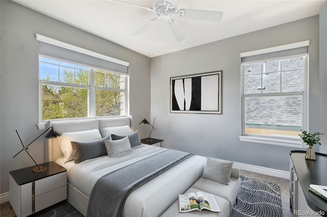 carpeted bedroom with multiple windows and ceiling fan