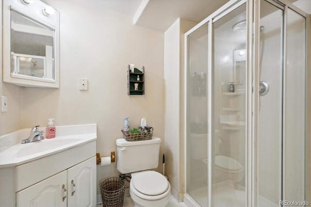 bathroom featuring walk in shower, vanity, and toilet