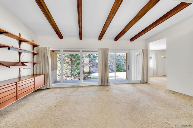 unfurnished living room featuring carpet flooring, lofted ceiling with beams, and visible vents