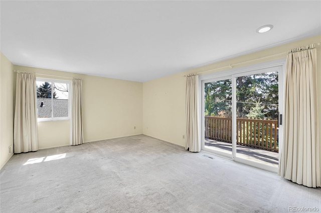 spare room with visible vents and light carpet