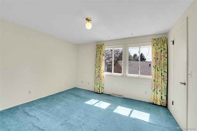 empty room with visible vents and carpet floors