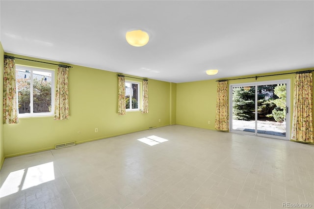 unfurnished room featuring visible vents and baseboards