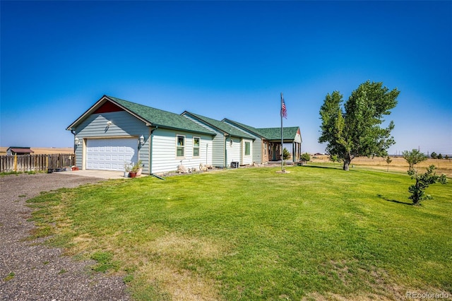 ranch-style house featuring a front lawn and a garage