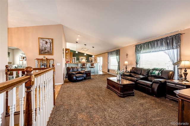 carpeted living room with vaulted ceiling