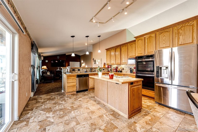 kitchen with kitchen peninsula, decorative backsplash, stainless steel appliances, pendant lighting, and a center island