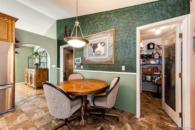 dining space featuring vaulted ceiling