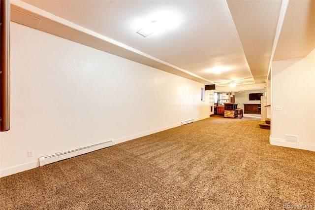 basement with carpet floors and a baseboard heating unit