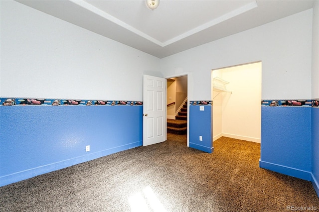 unfurnished bedroom featuring a spacious closet